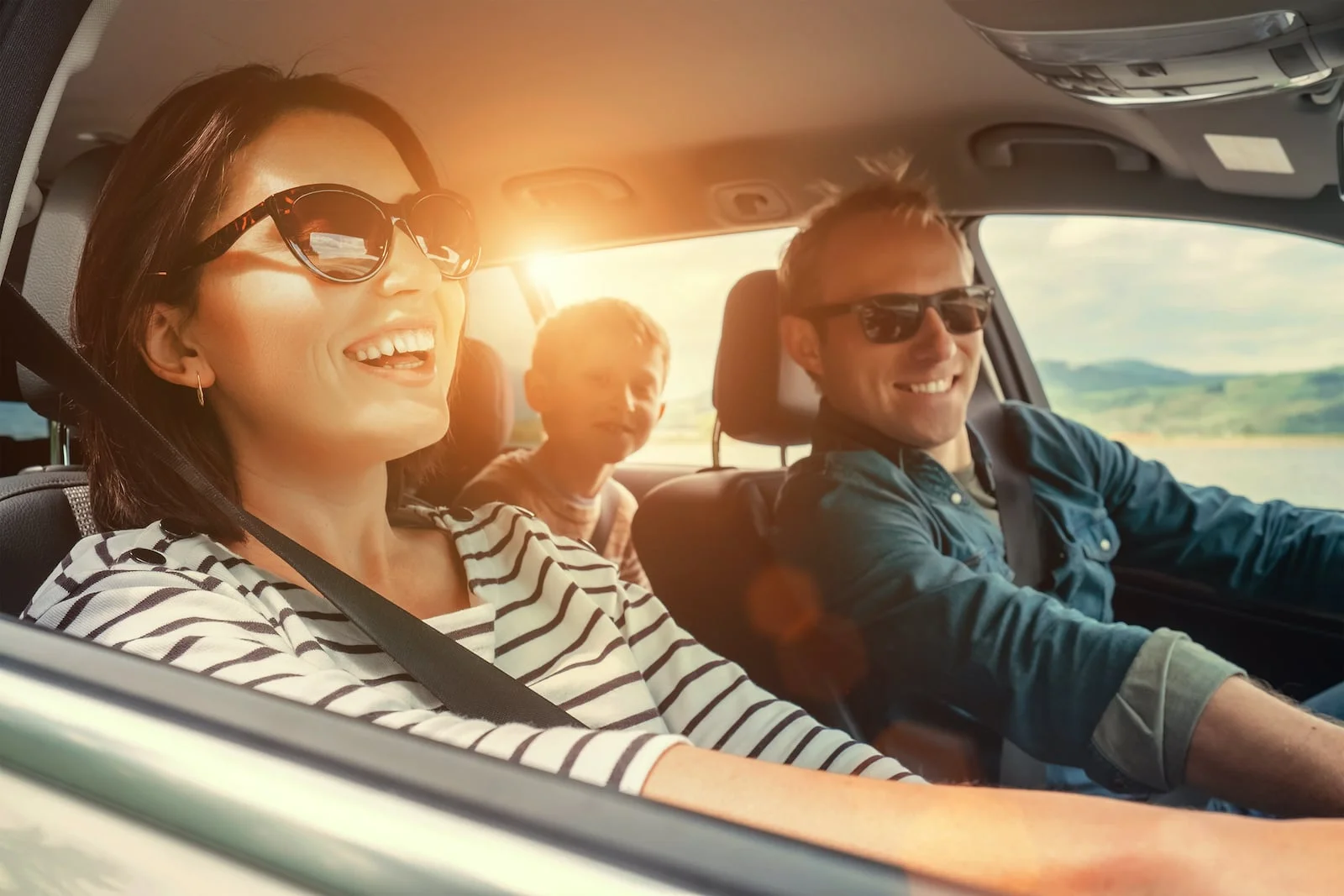 family in car smiling